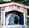 Bread oven. A good sized wood fire is made inside the oven,
			and is allowed to burn for several hours. The walls and ceiling (4 to 6 inches thick) absorb the heat. 
			The excess wood and ash are removed. The oven is then ready to use for hours of baking breads, pizza, etc