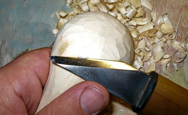 carving back of spoon with straight knife